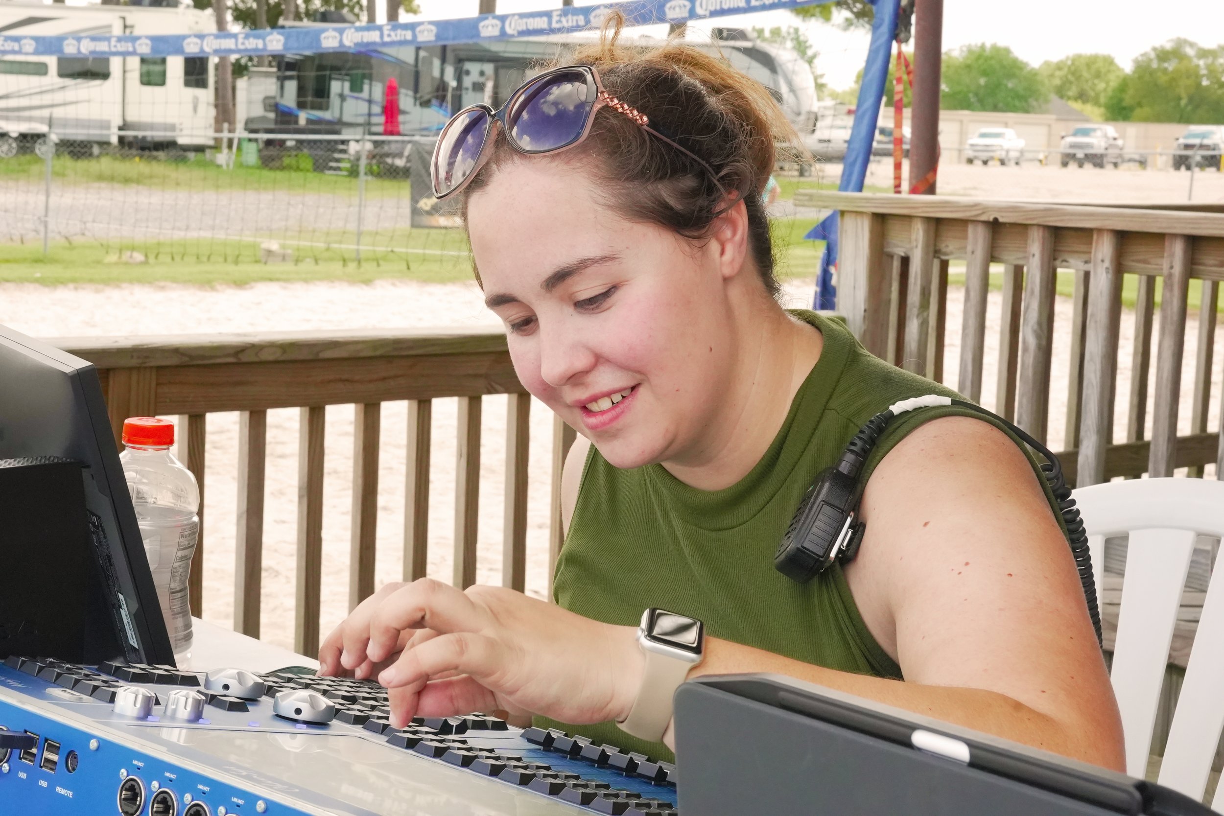 WBSAV staff member working remotely on a laptop at an outdoor location, showcasing flexibility, dedication, and modern AV operations in action.