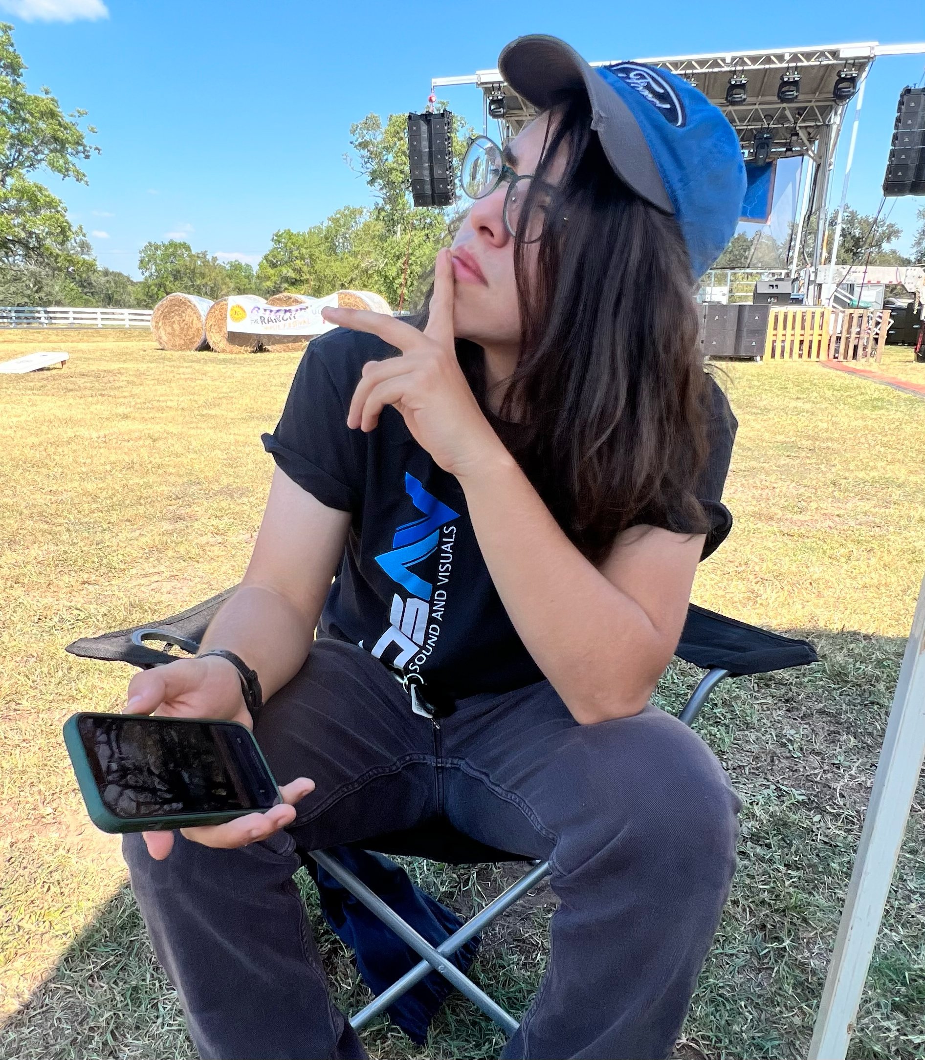 WBSAV team member seated on a camping chair outdoors, capturing the blend of work-life balance, community, and personality at the heart of the company.